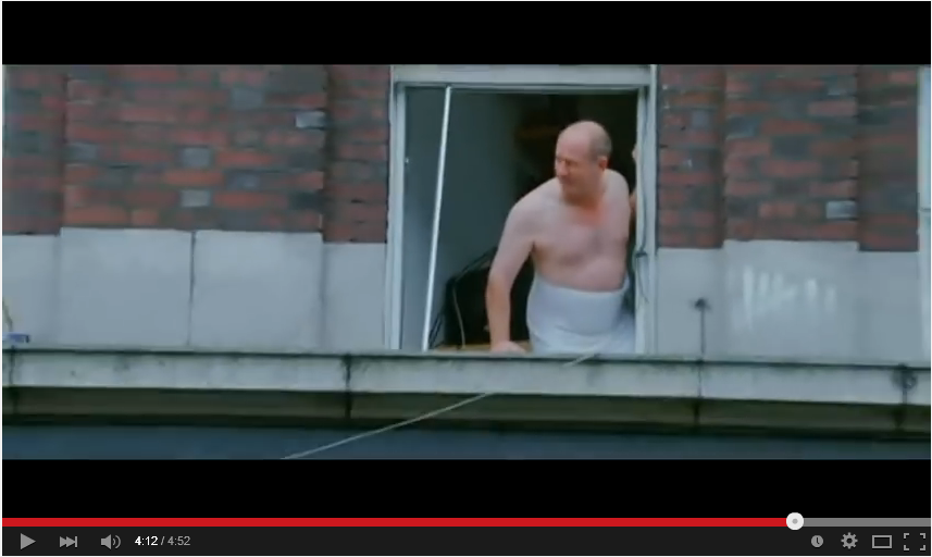 Man in towel looks on at impending Luas disaster.