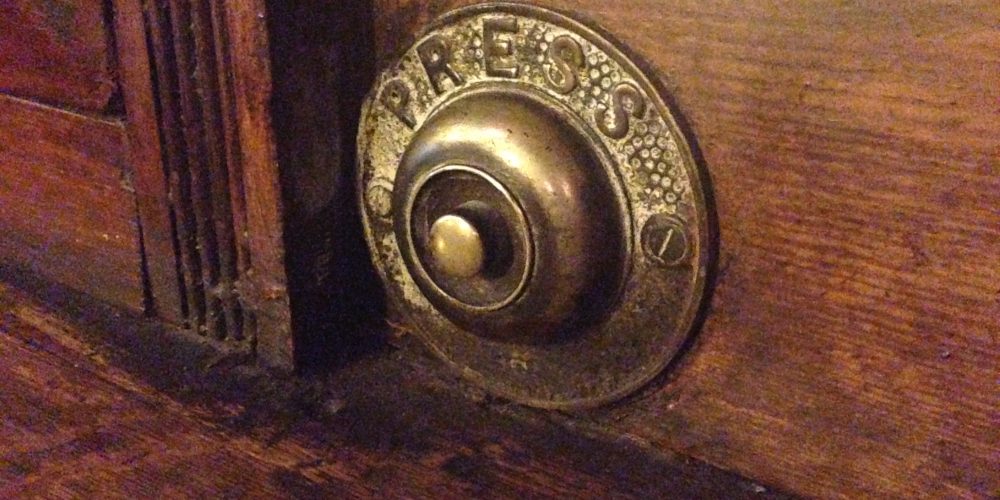 Press for service. When pubs had bells to call the bartender.